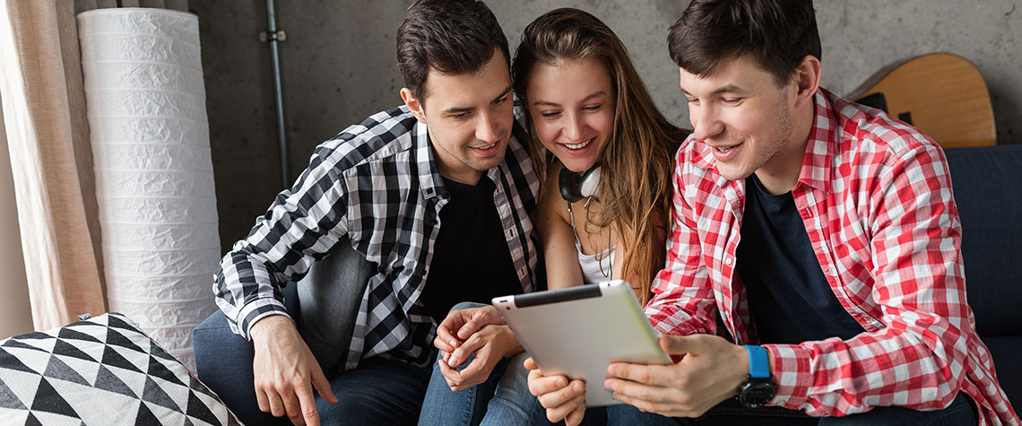 happy young people having fun, friends party at home on tablet. mushroom side effects long term.