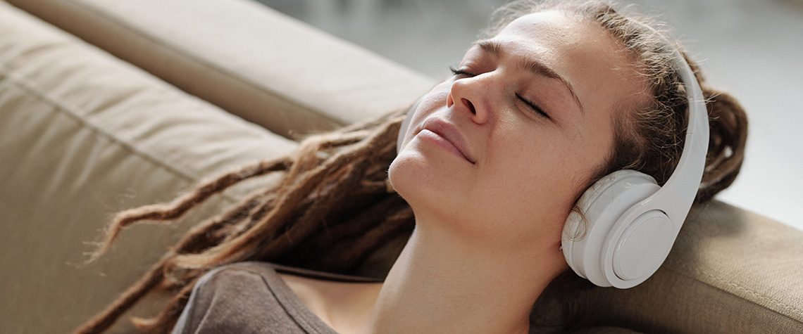 Relaxed girl with headphones. How to recover from a bad shroom trip. buy albino penis envy shrooms online.