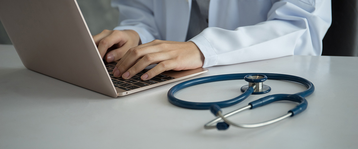 Medical doctor working with laptop researching the benefits of medicinal mushrooms. buy shrooms online canada.