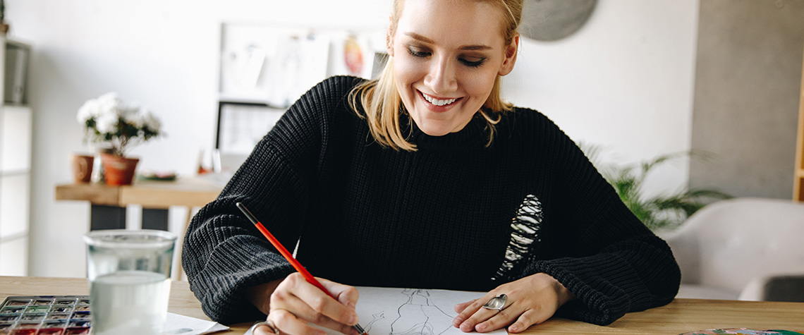 cheerful young fashion designer drawing while on penis envy shrooms