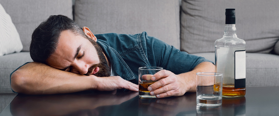 Drunk man sleeping on table. using mushrooms for anxiety.