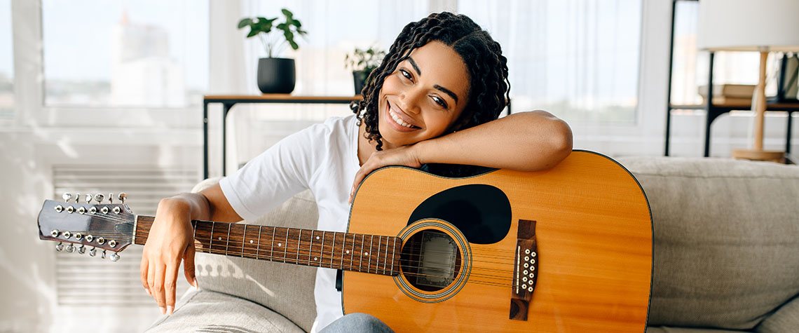 Happy woman with guitar. Buy amazonian cubensis shrooms online canada.