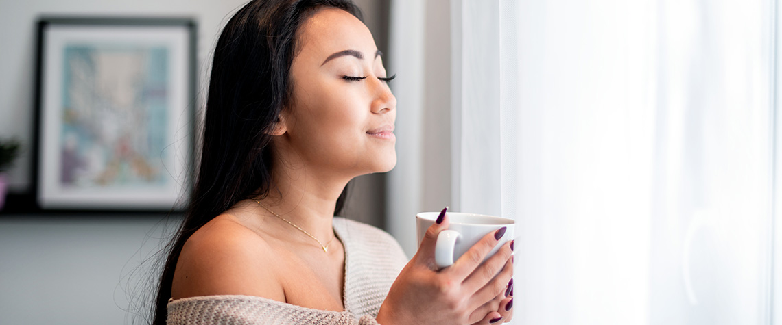 Relaxed woman with cup of magic mushroom tea. how to make shroom tea. how to make tea with shroom powder.